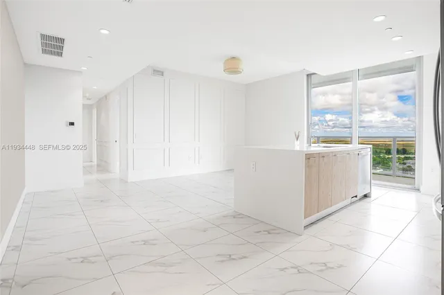 a view of kitchen with stainless steel appliances cabinets and outdoor space