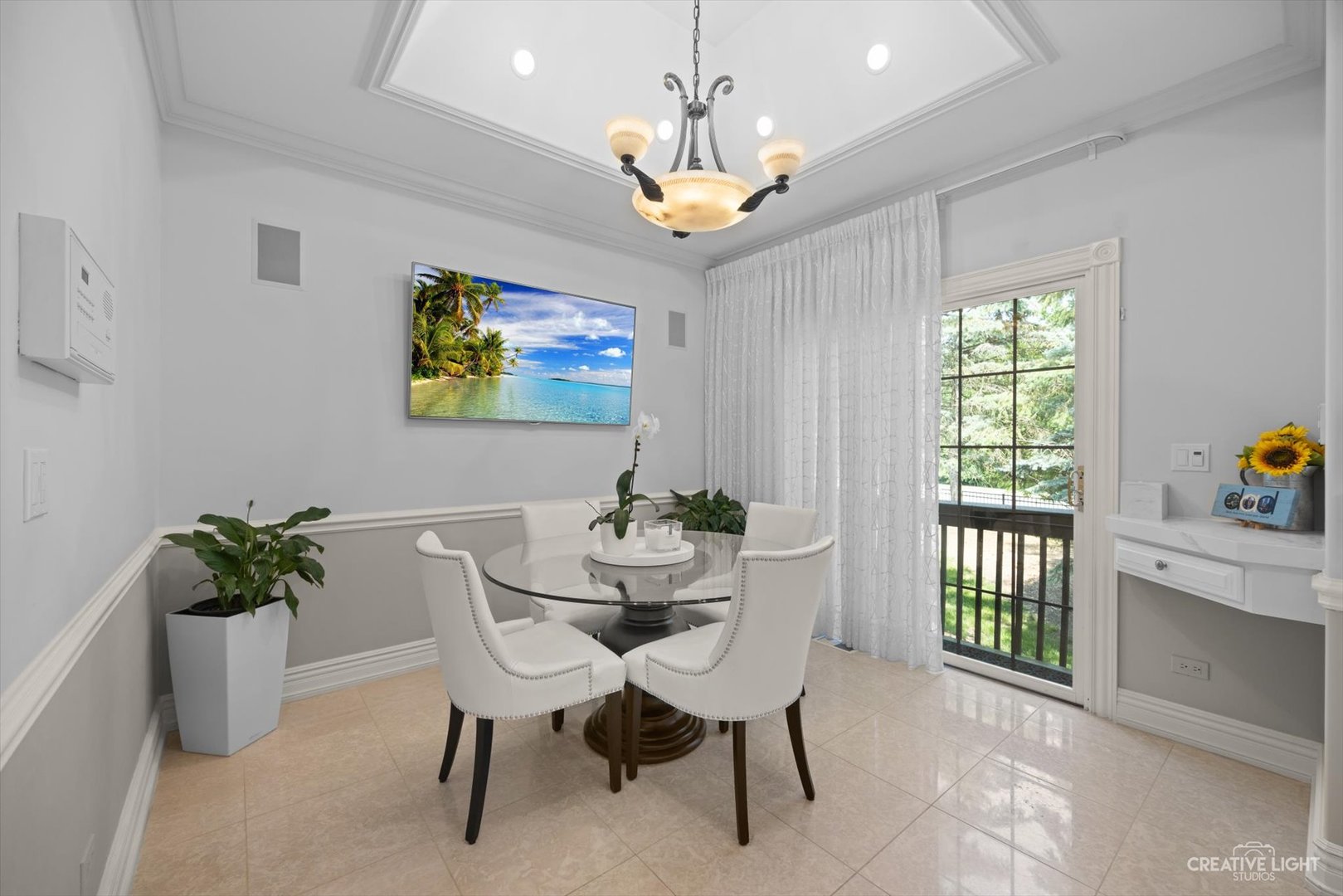 1201 Kenmare Drive Burr Ridge, IL 60527 - Photo 15 of 53 a dining room with furniture a potted plant and a chandelier