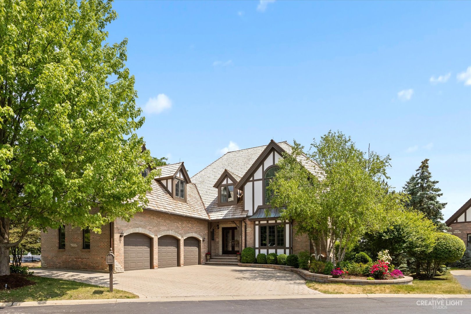 1201 Kenmare Drive Burr Ridge, IL 60527 - Photo 2 of 53 a front view of a house with a yard