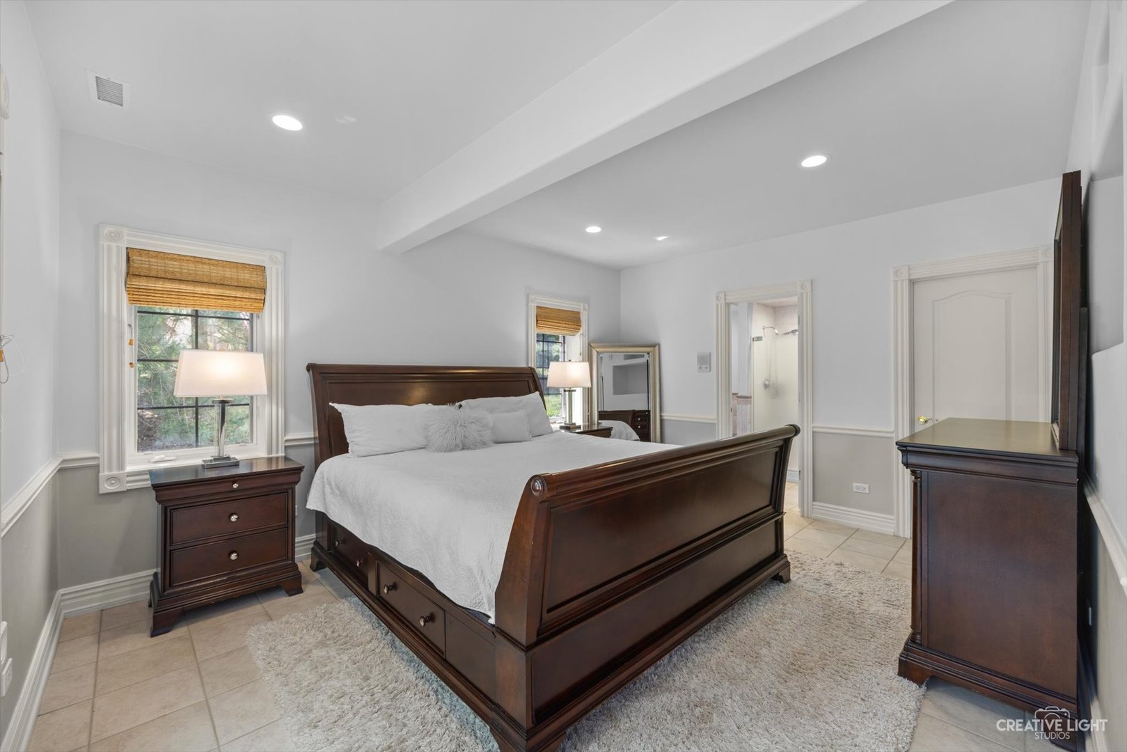 1201 Kenmare Drive Burr Ridge, IL 60527 - Photo 39 of 53 a spacious bedroom with a bed and wooden floor