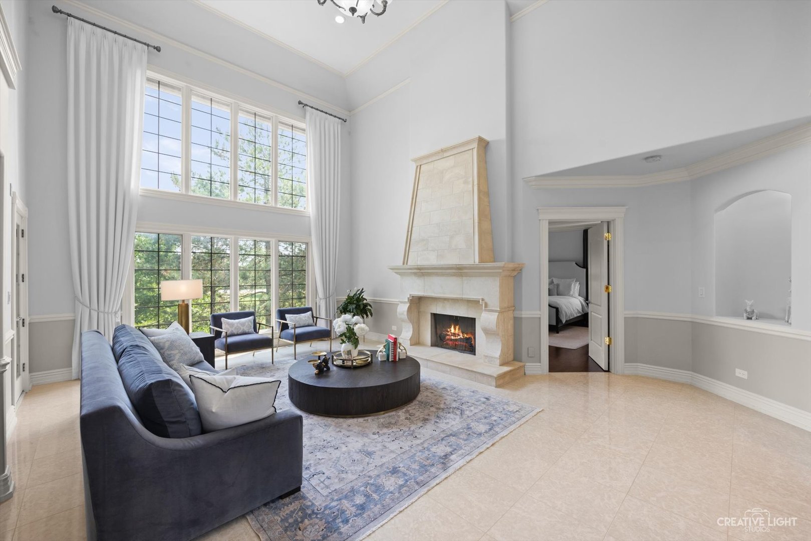 1201 Kenmare Drive Burr Ridge, IL 60527 - Photo 7 of 53 a living room with furniture a fireplace and a large window