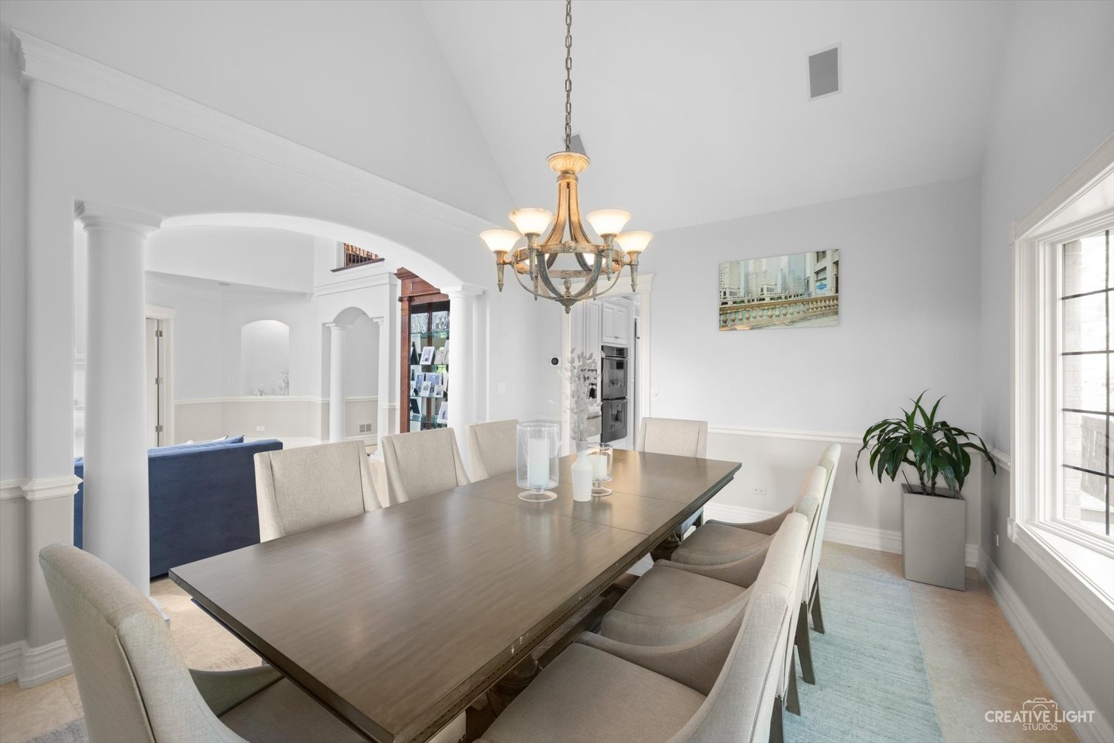 1201 Kenmare Drive Burr Ridge, IL 60527 - Photo 9 of 53 a dining room with wooden floor a chandelier a wooden table and chairs