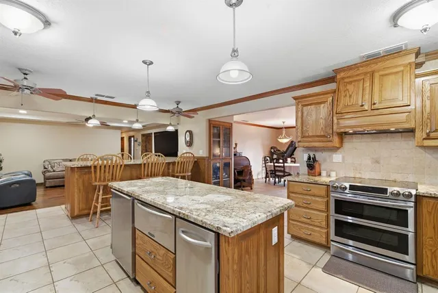 a kitchen with stainless steel appliances granite countertop a sink and cabinets