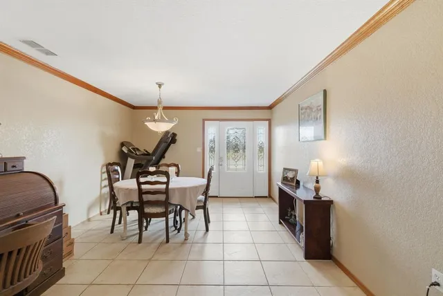 a dining room with furniture and wooden floor