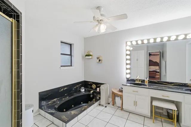 a kitchen with granite countertop a refrigerator a stove a sink and dishwasher