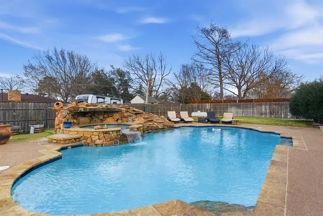 a front view of a house with swimming pool having outdoor seating
