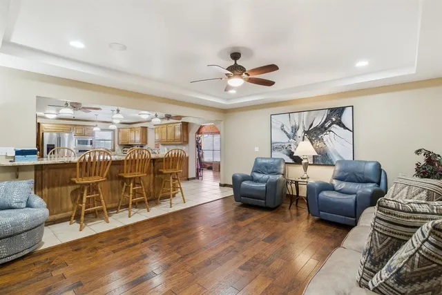 a living room with furniture and wooden floor