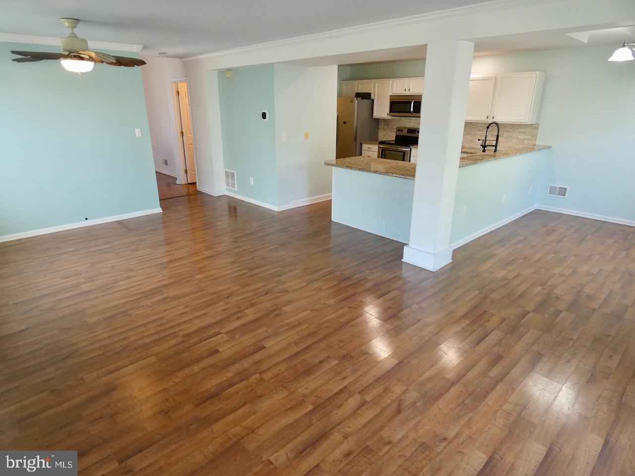 335 Marldale Drive Middletown, DE 19709 - Photo 16 of 58 a view of a kitchen with wooden floor and a refrigerator