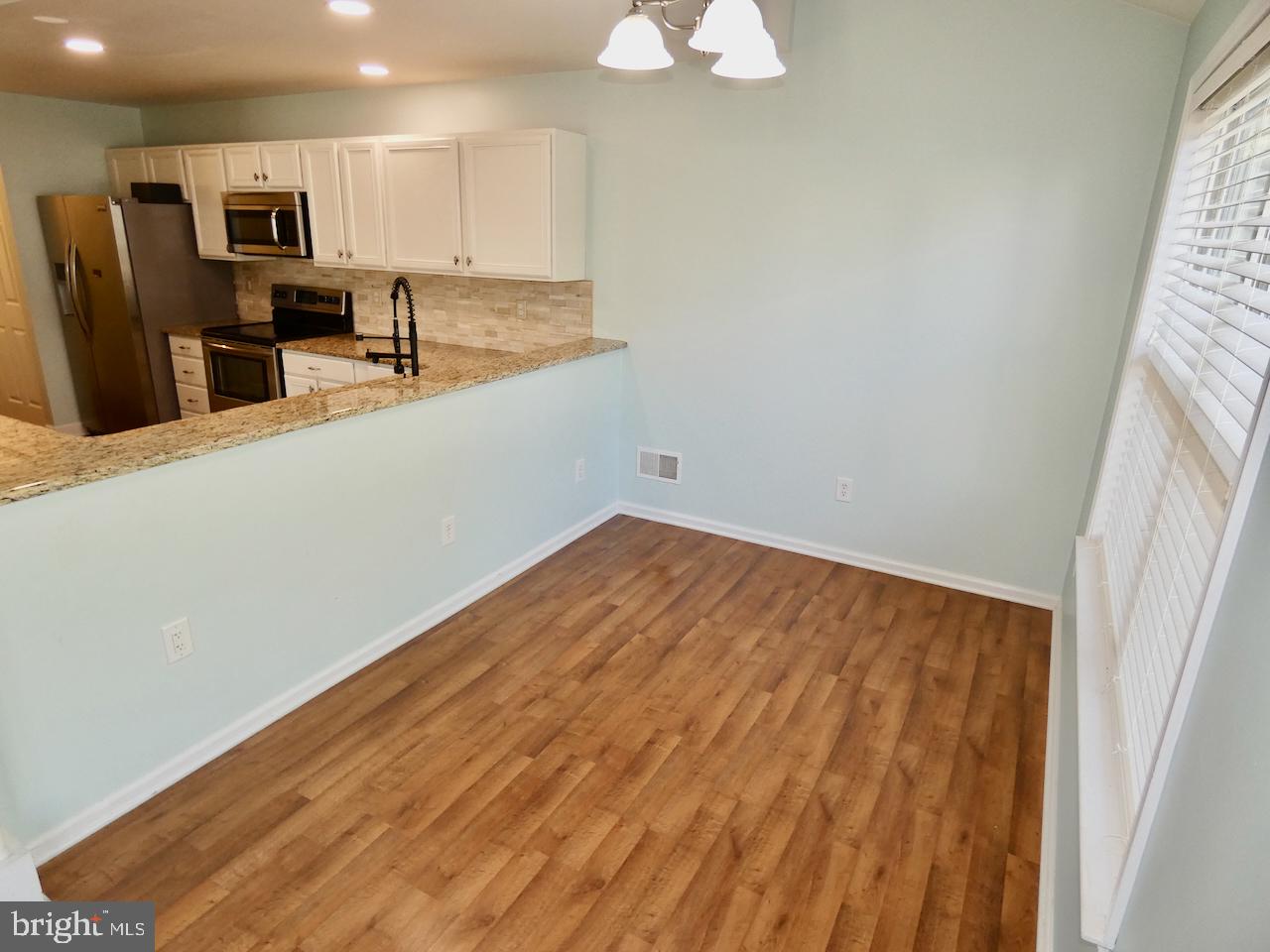 335 Marldale Drive Middletown, DE 19709 - Photo 18 of 58 wooden floor in an empty room with a window