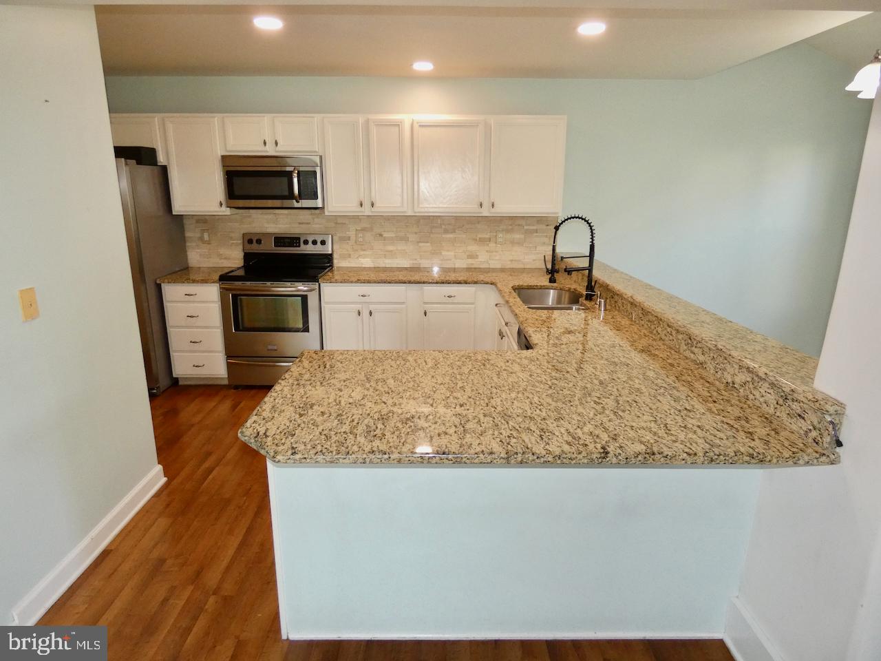 335 Marldale Drive Middletown, DE 19709 - Photo 22 of 58 a kitchen with kitchen island a sink stainless steel appliances and a counter top space