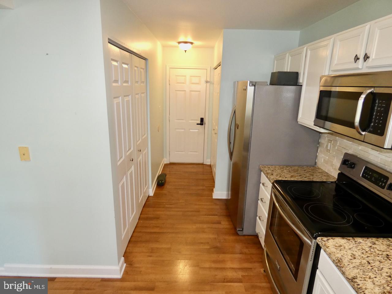 335 Marldale Drive Middletown, DE 19709 - Photo 25 of 58 a kitchen with granite countertop a refrigerator and a stove top oven