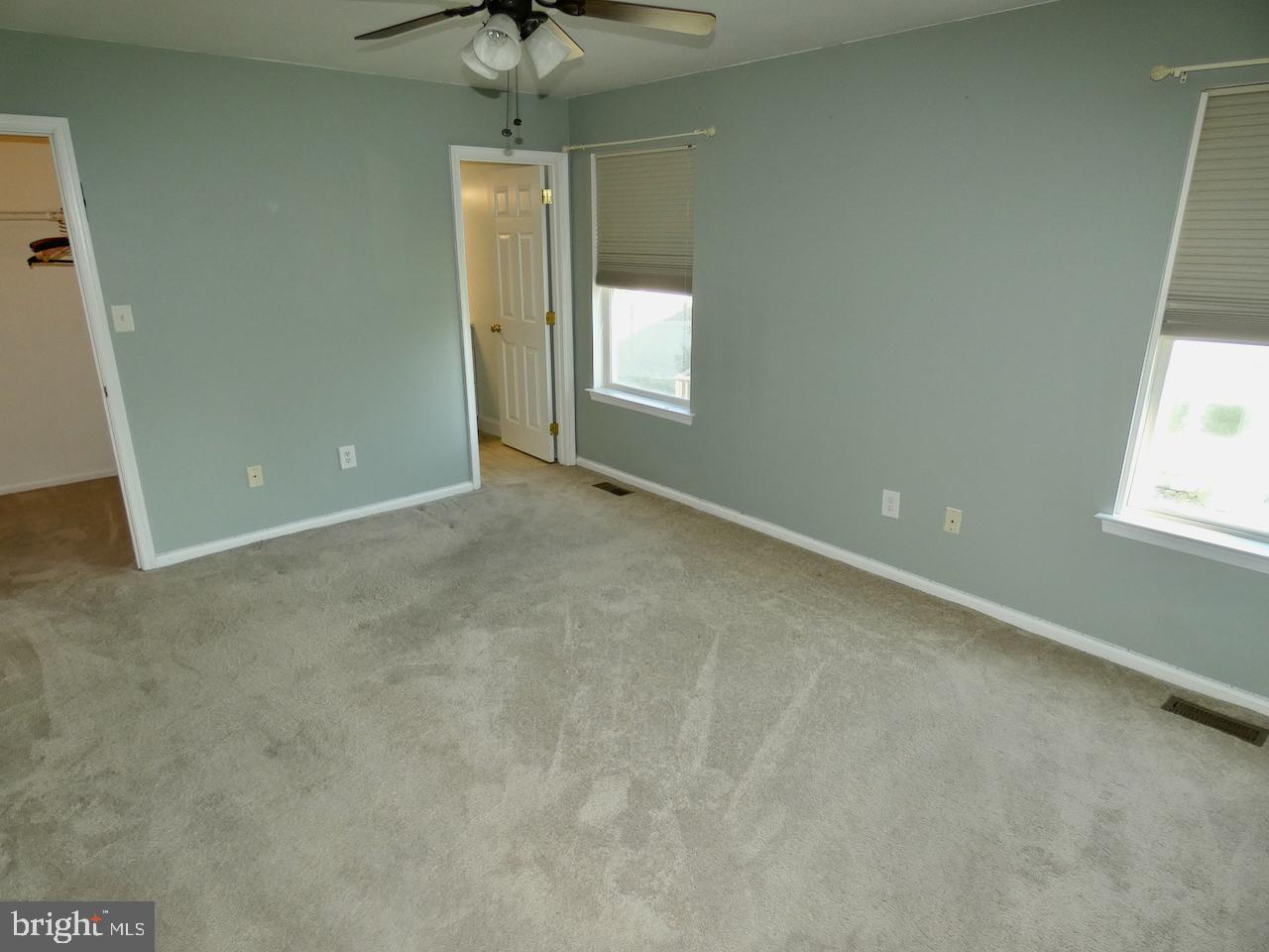 335 Marldale Drive Middletown, DE 19709 - Photo 29 of 58 an empty room with a chandelier fan and windows