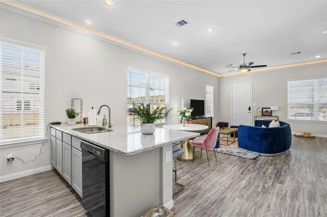 a kitchen with sink and cabinets