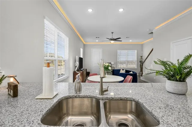 a kitchen with a sink and a granite counter tops