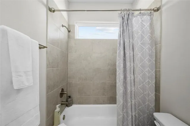 a bathroom with a shower and a toilet