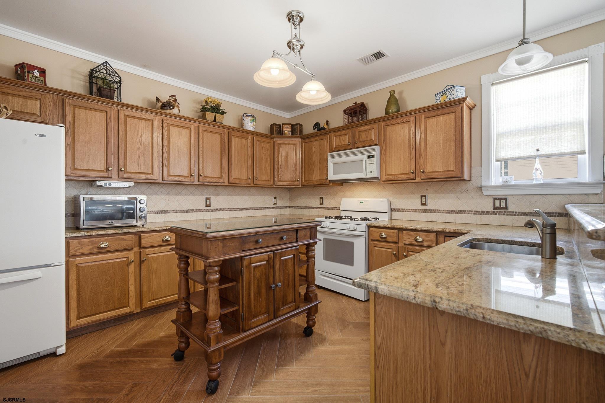 102 Warwick Road Galloway Township, NJ 08205 - Photo 10 of 45 a kitchen with a stove sink and cabinets