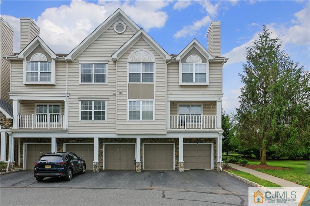 a car parked in front of a brick house with a large windows