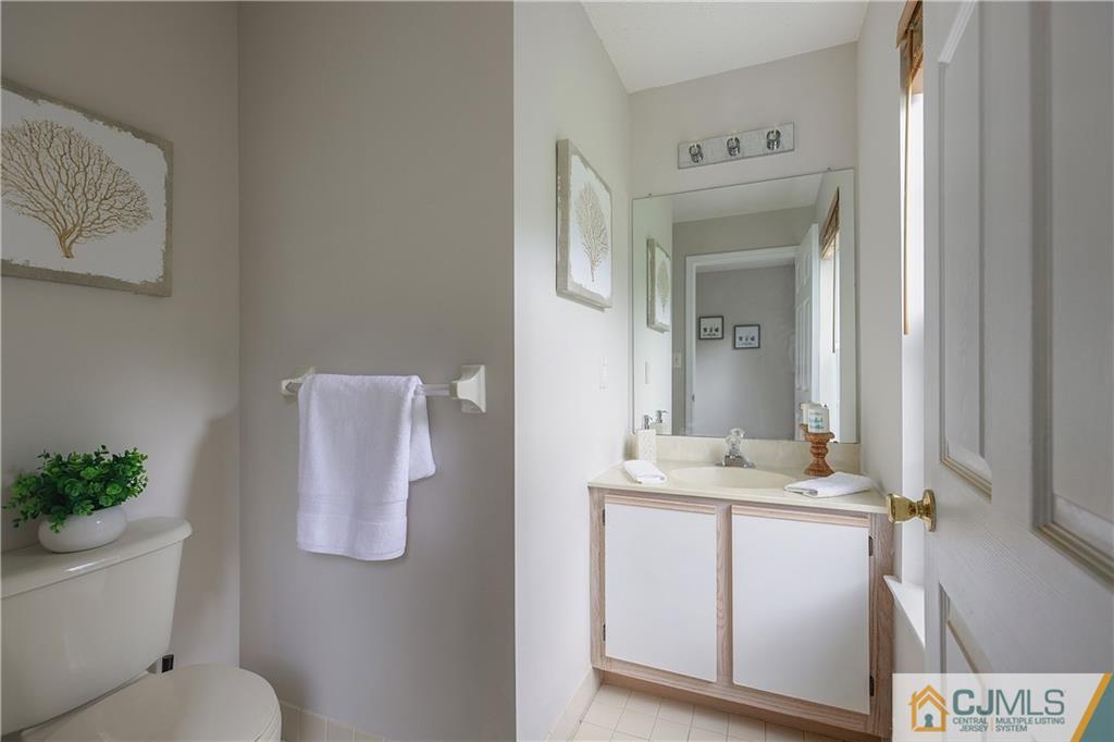 53 Prestwick Way Edison, NJ 08820 - Photo 12 of 28 a bathroom with a granite countertop sink and a mirror
