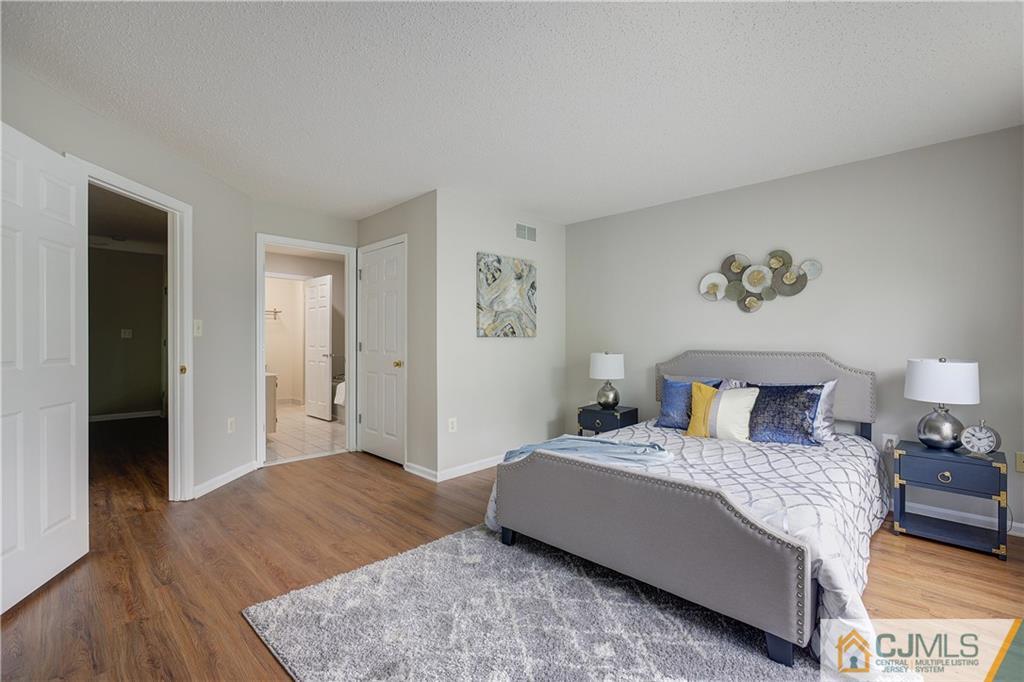 53 Prestwick Way Edison, NJ 08820 - Photo 14 of 28 a bedroom with a bed and wooden floor