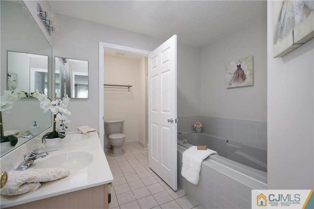 53 Prestwick Way Edison, NJ 08820 - Photo 15 of 28 a bathroom with a sink a toilet and shower