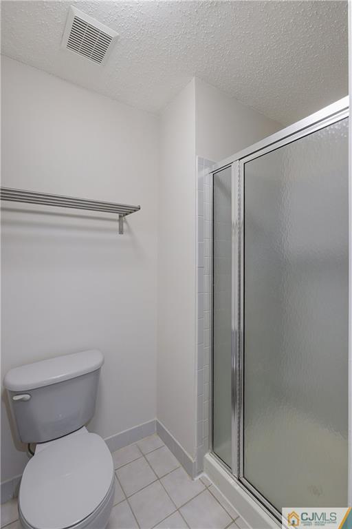 53 Prestwick Way Edison, NJ 08820 - Photo 16 of 28 a white toilet sitting next to a shower