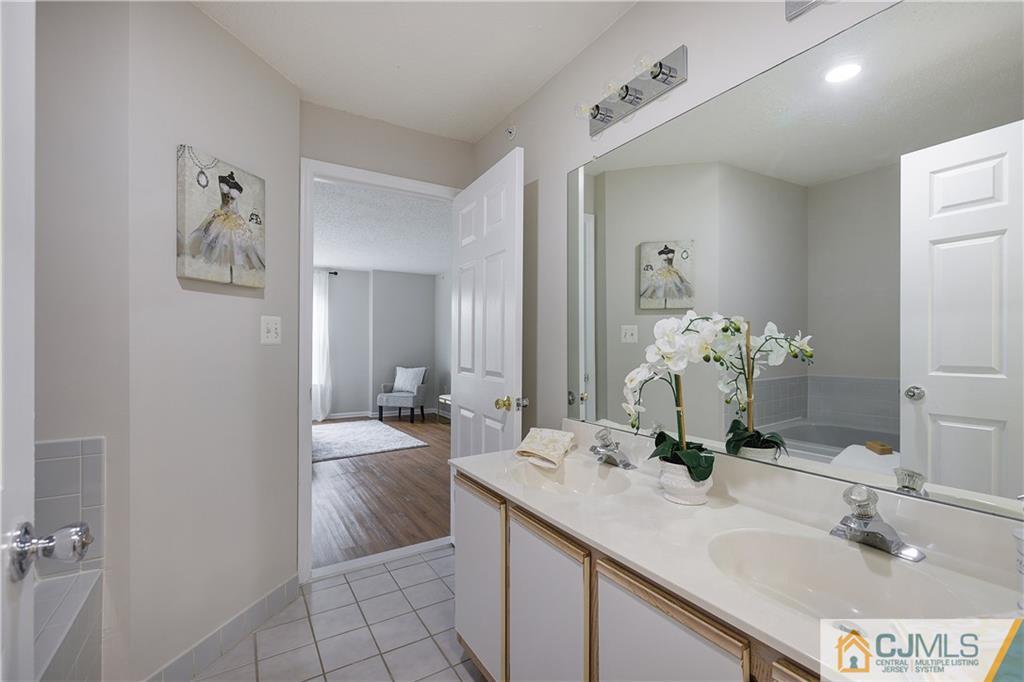53 Prestwick Way Edison, NJ 08820 - Photo 17 of 28 a bathroom with a granite countertop sink a toilet and a mirror