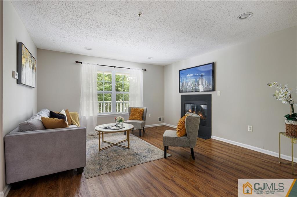 53 Prestwick Way Edison, NJ 08820 - Photo 7 of 28 a living room with furniture and a fireplace
