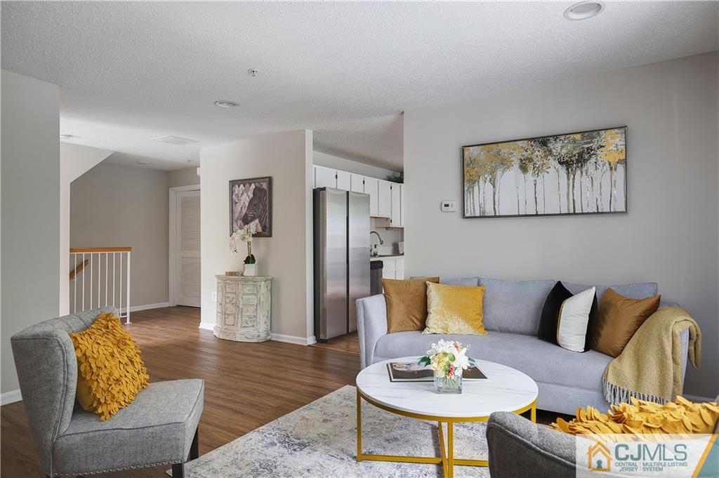 53 Prestwick Way Edison, NJ 08820 - Photo 8 of 28 a living room with furniture and a dining table with wooden floor
