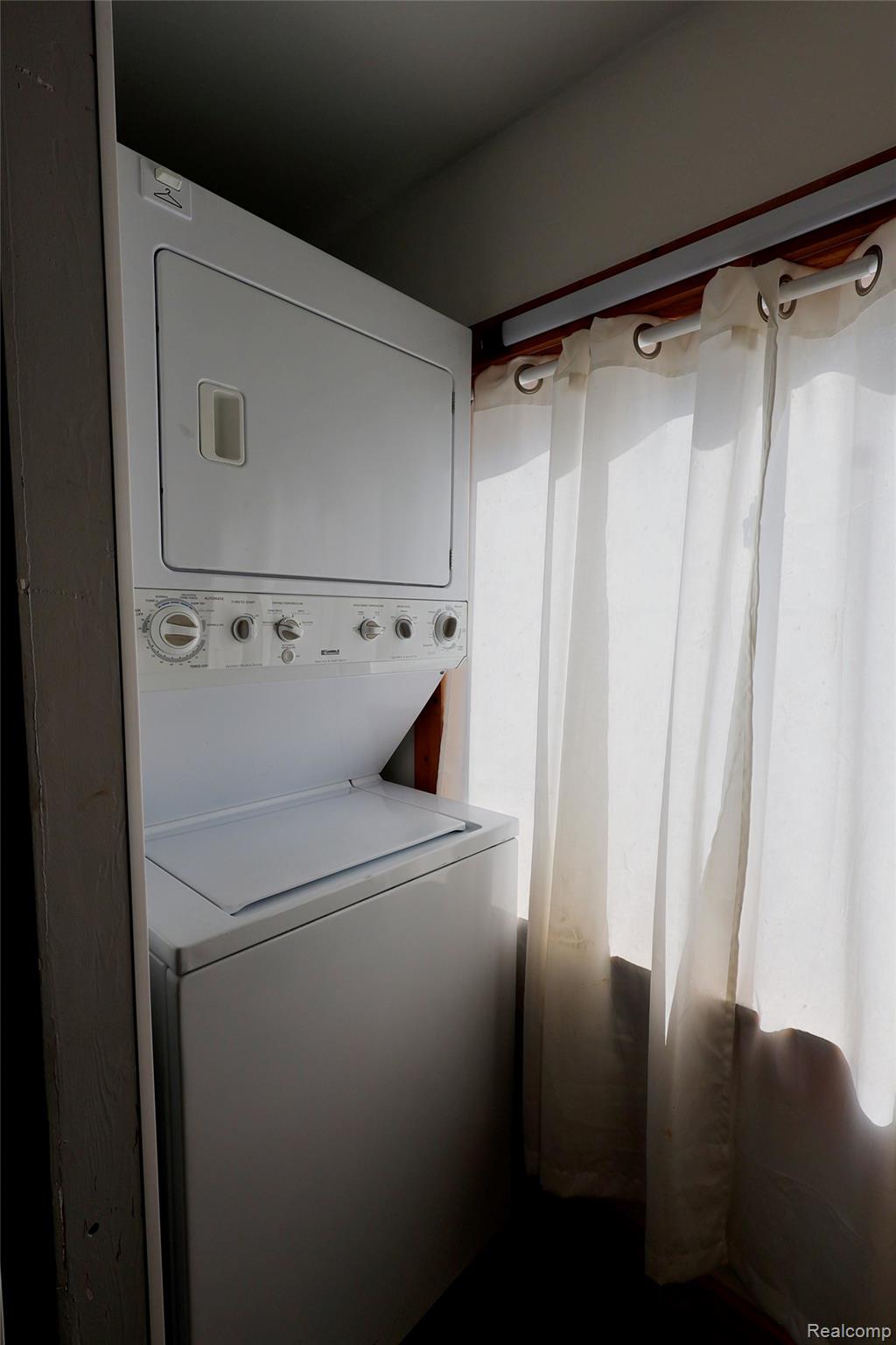 15676 Frazho Road Roseville, MI 48066 - Photo 13 of 20 Stackable white washer and dryer unit, featuring a top-load washer and front-load dryer