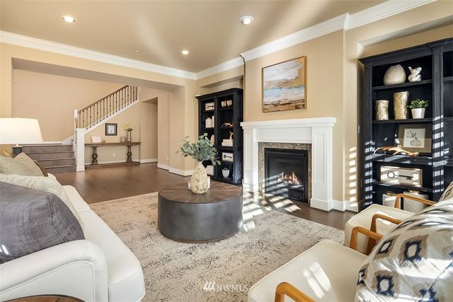 a living room with furniture a fireplace and wall paintings