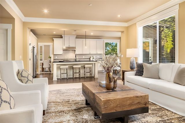 a living room with fireplace furniture and a table