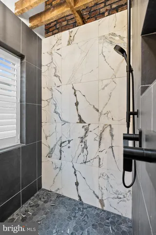 a backyard of a house with wooden floor and outdoor seating