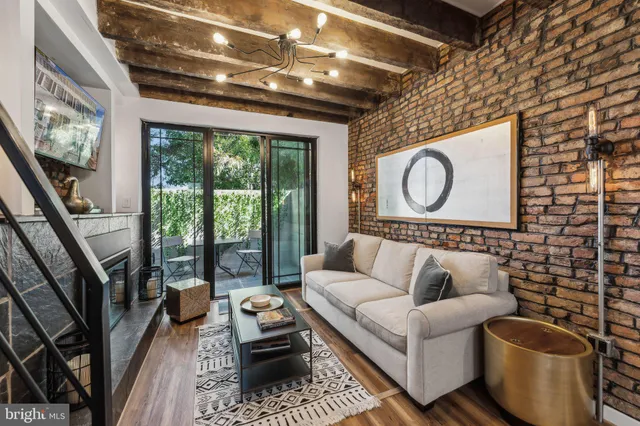 a living room with furniture a rug and a large window