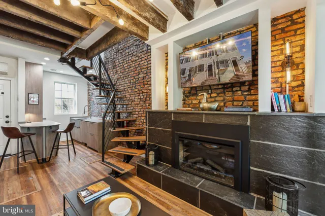 a living room with furniture a dining table and wooden floor