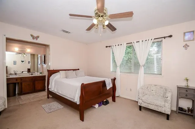 a bedroom with furniture and a flat screen tv