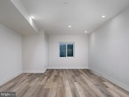 a view of a room with a white wall and a window