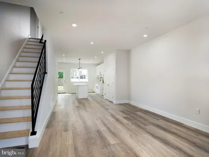 a bathroom with a granite countertop sink a toilet and a mirror