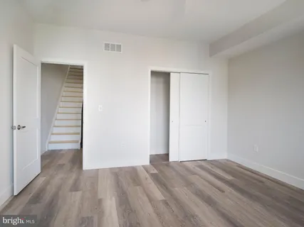 a large room with a lot of cabinets and wooden floor
