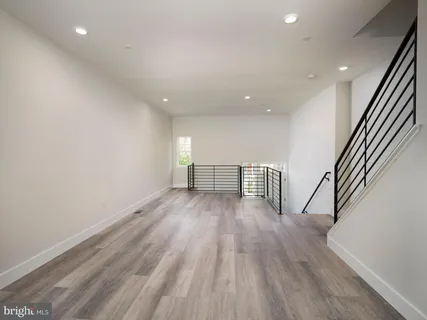 a large kitchen with a lot of counter space and a wooden floor