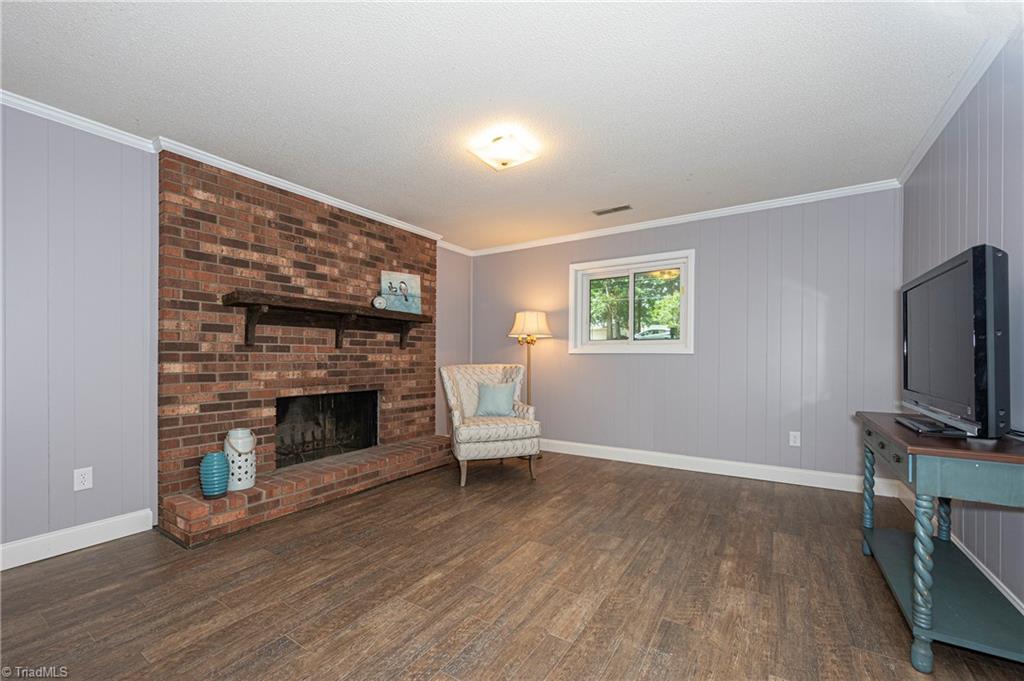 128 Westridge Road Advance, NC 27006 - Photo 25 of 30 Lower level den with wood-burning fireplace