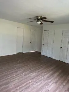 a view of empty room with wooden floor