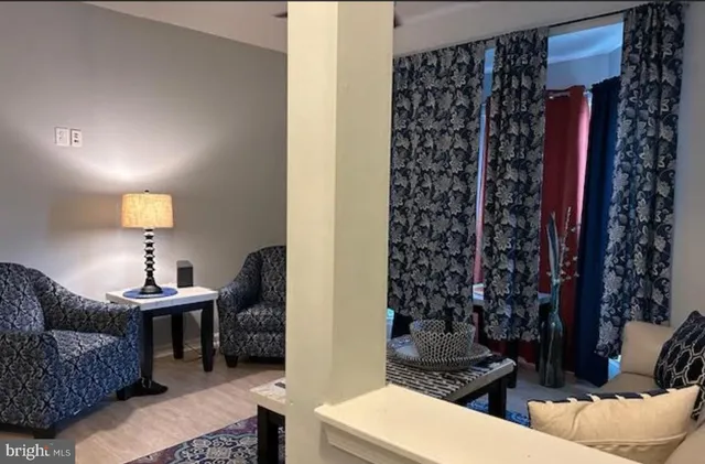 a living room with furniture and a potted plant