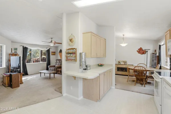 a kitchen with a sink a refrigerator and cabinets