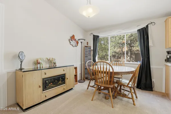 a view of a dining room with furniture window and outside view