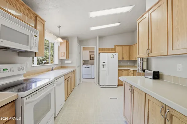 a utility room with cabinets washer and dryer