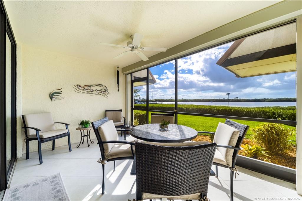 3100 Southeast Pruitt Road, Unit F101 Port St. Lucie, FL 34952 - Photo 7 of 37 Screened porch with door to docks & lawn
