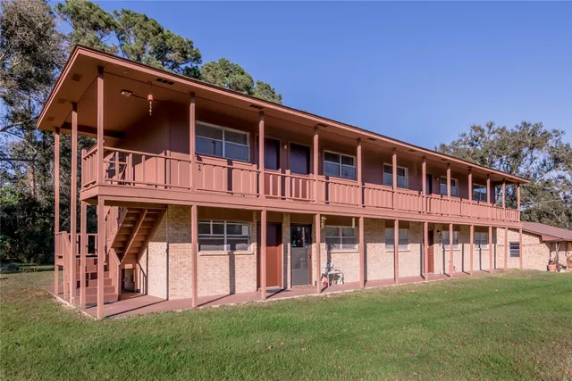 a big building with a big yard and large trees