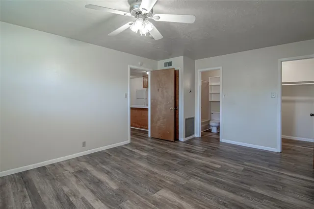 a view of an empty room with wooden floor