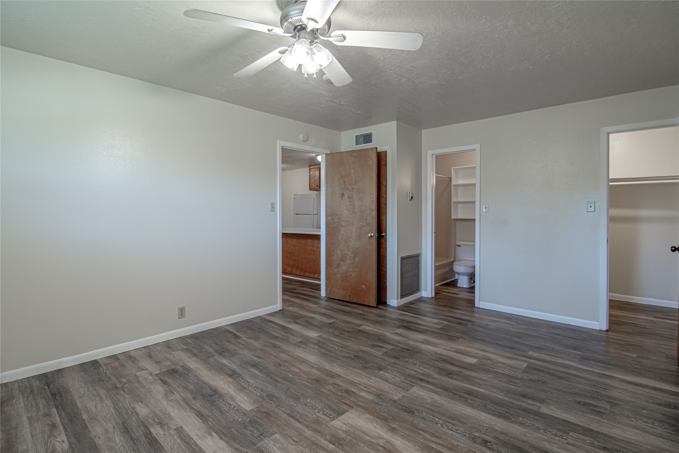 120 McAdams Lane, Unit F Huntsville, TX 77320 - Photo 13 of 21 a view of an empty room with wooden floor