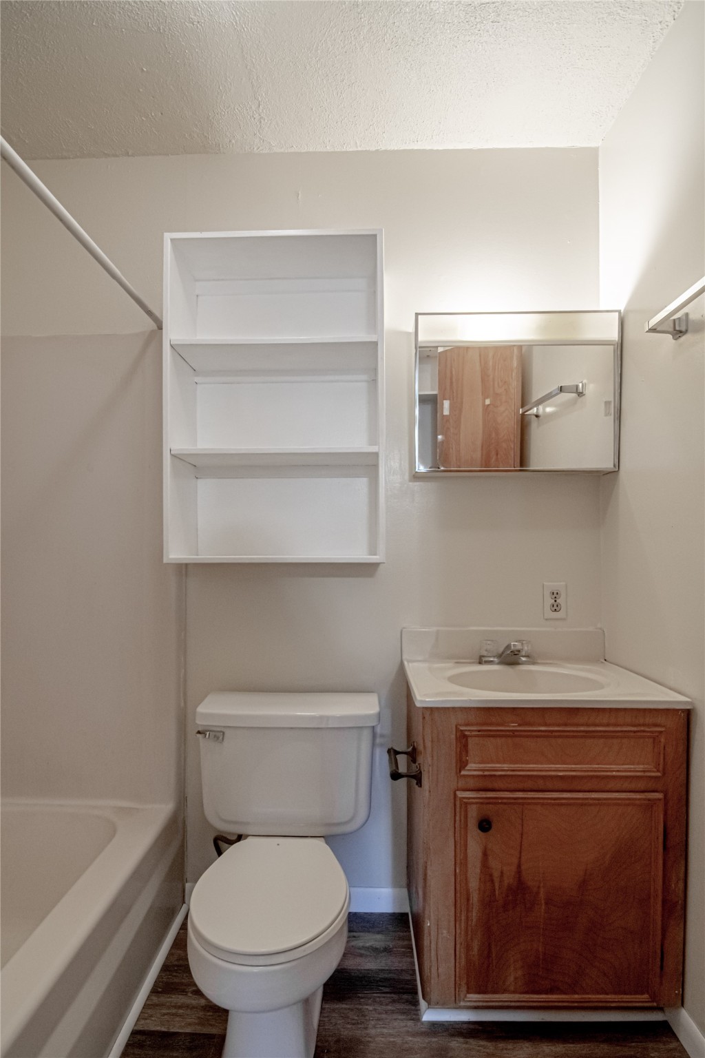 120 McAdams Lane, Unit F Huntsville, TX 77320 - Photo 15 of 21 a bathroom with a toilet a sink and bathtub